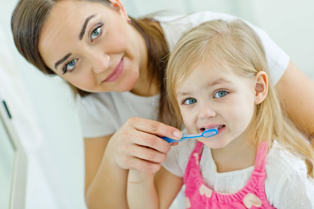 Mom and Daughter Learning How to Brush Teeth